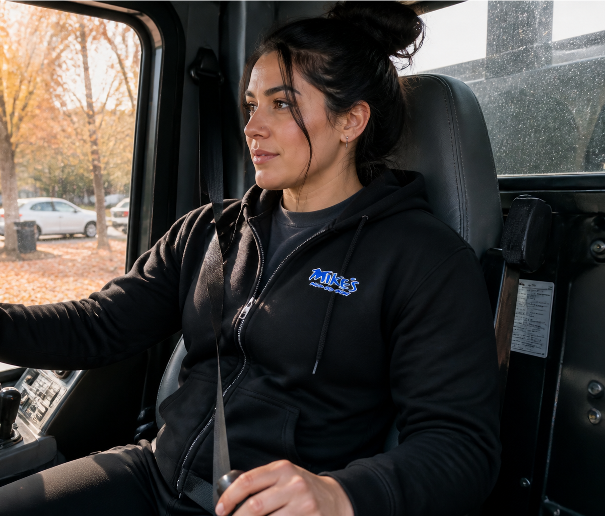 Tow truck driver wearing a black custom full-zip hoodie