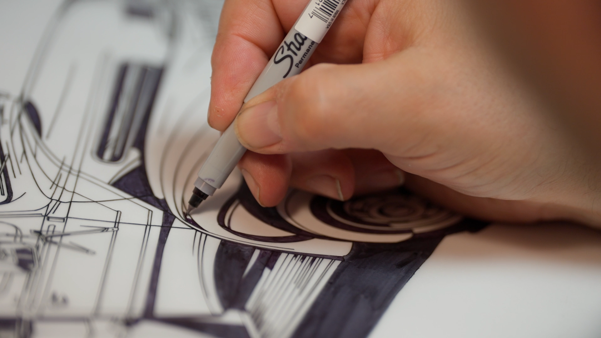 Excel Sportswear artist inking a custom school design